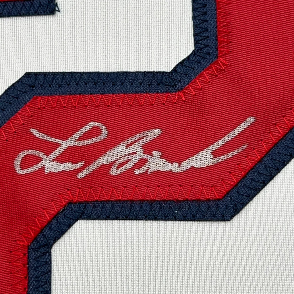 Red and white Lou Brock sports jersey with black trim and autographed photos
