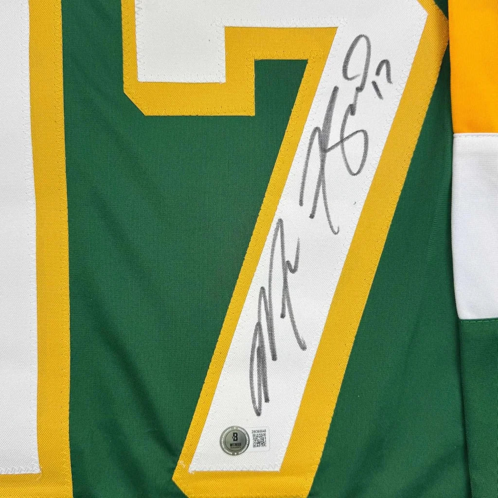 Framed autographed green and yellow minnesota hockey jersey with number 7 and white signature strip along the side