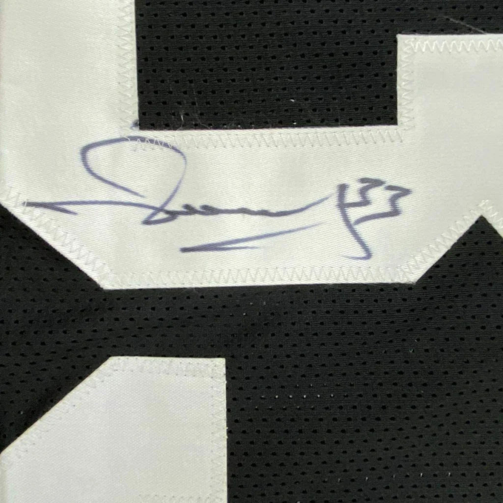 Black sports jersey with white number and blue autograph in a professionally framed Merril Hoge Steelers display