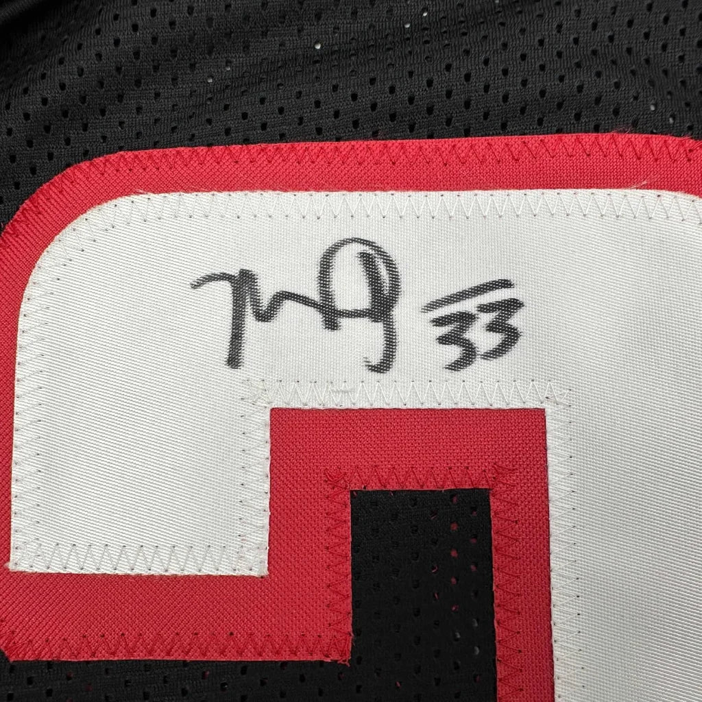 Framed autographed Michael Turner Atlanta Falcons black jersey number 33 Beckett COA