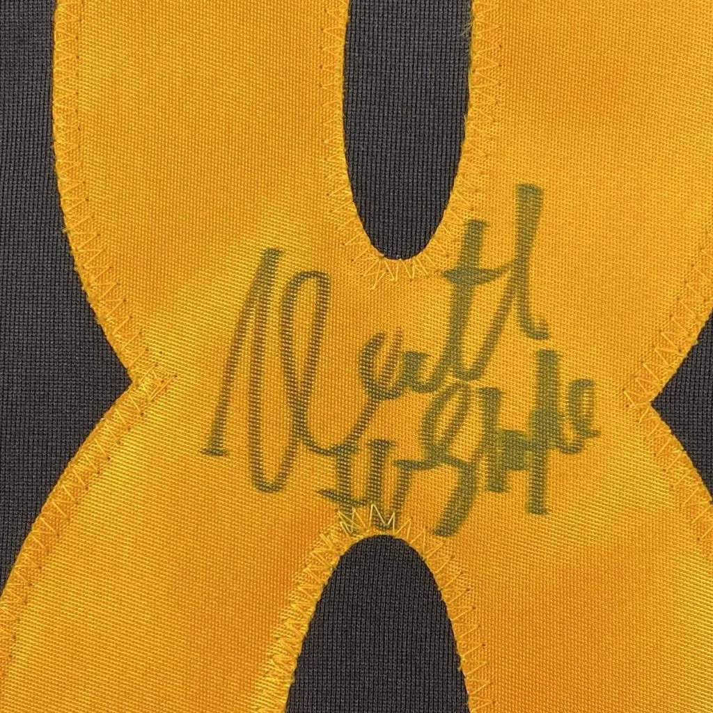 Vibrant yellow Michael Myers Halloween jersey patch with green embroidered signature