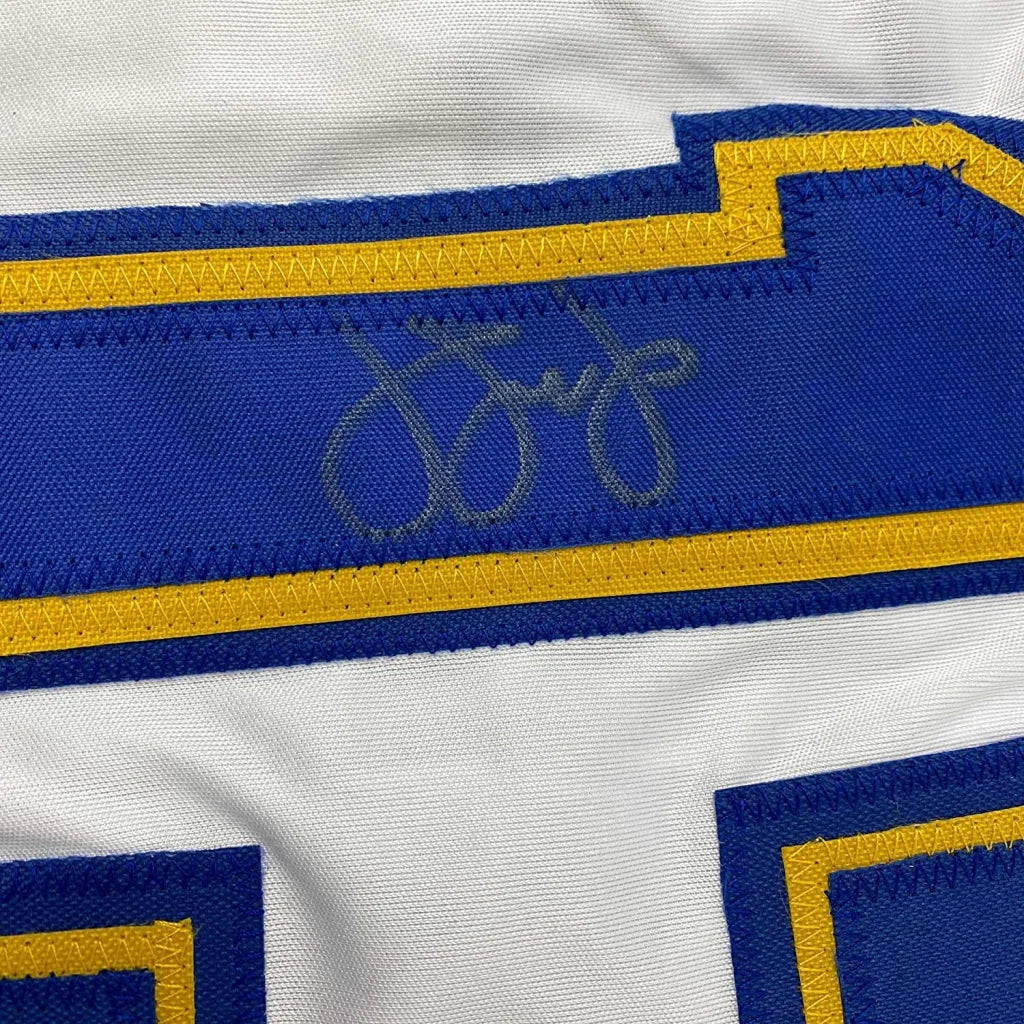 White sports jersey with blue yellow trim and faded autograph for Legendary Baseball Jersey