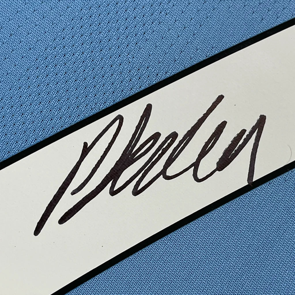 Light blue FODEN 47 soccer jersey with black handwritten signature ready to display