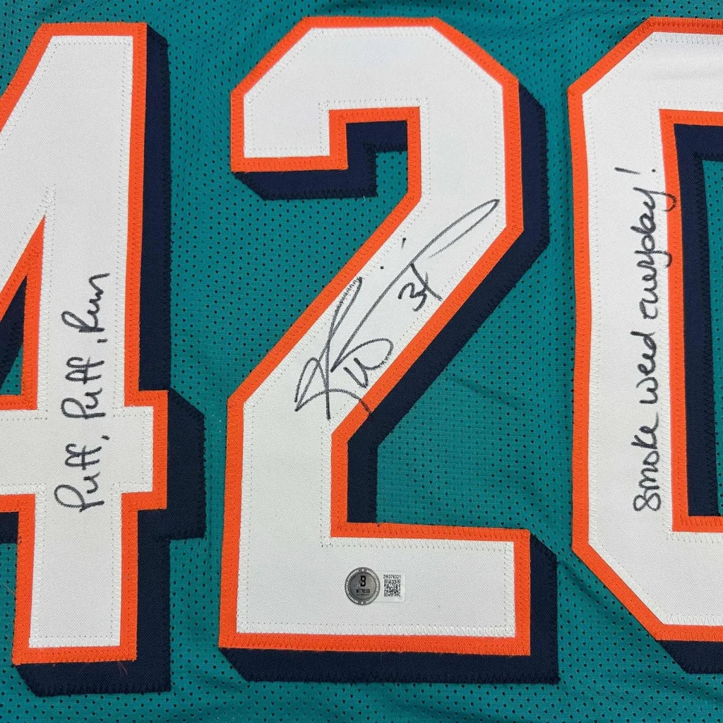 Framed autographed Ricky Williams teal Miami Dolphins jersey #42 back