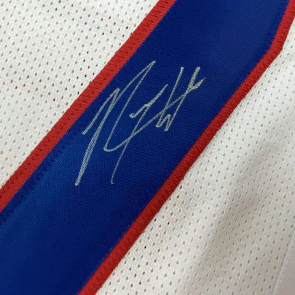 Autographed white Giants jersey with red and blue trim in a professionally framed display