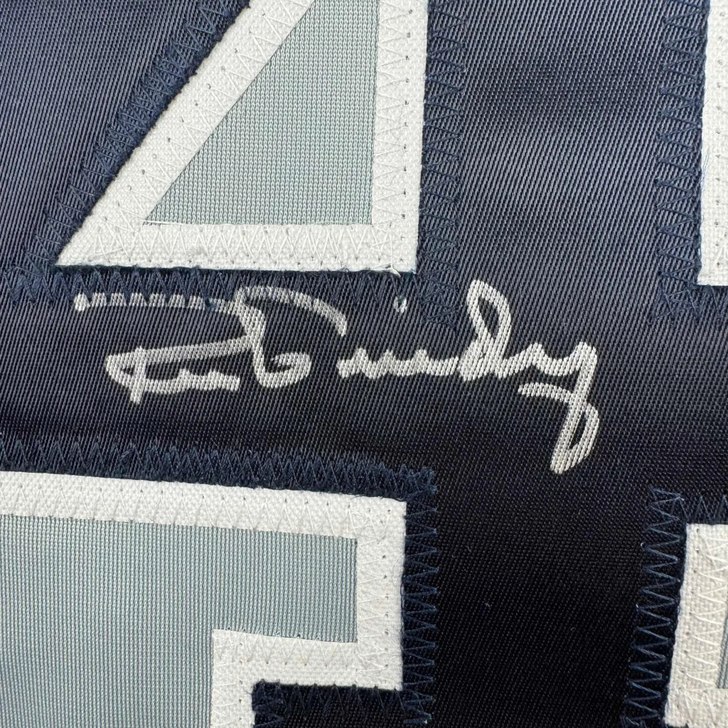 Autographed navy blue athletic jersey with light blue and white numbers, professionally framed