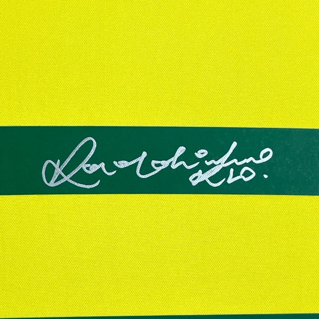 Framed autographed Ronaldinho Brazil yellow soccer jersey with stripes and signature