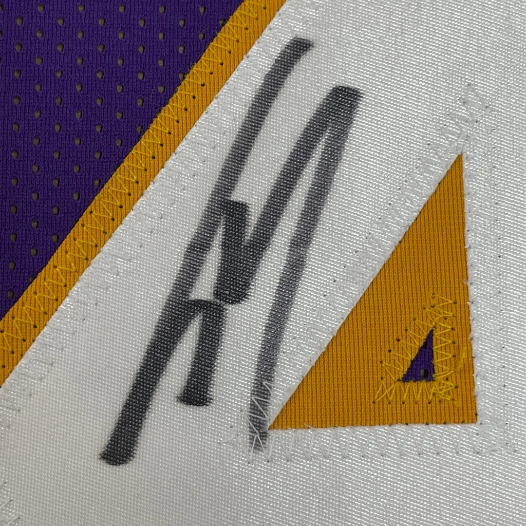 Black ink signature on a white purple and gold mesh los angeles lakers basketball jersey signed by shaquille shaq oneal