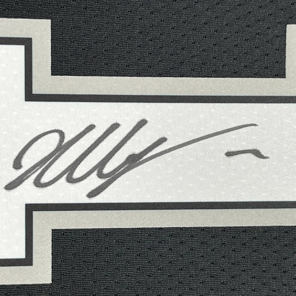 Autographed Victor Wembanyama Spurs jersey with action photos framed for display