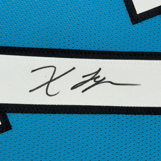 Black signature on white stripe of blue perforated athletic jersey in framed autographed Xavier Legette football jersey