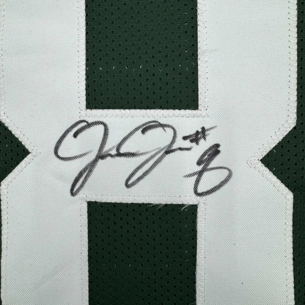 Dark green Packers sports jersey with white numbers and a black autograph ready to hang