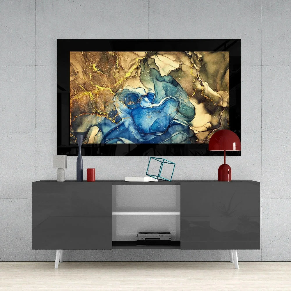 Modern swirling blue gold glass wall art with glossy finish in black frame