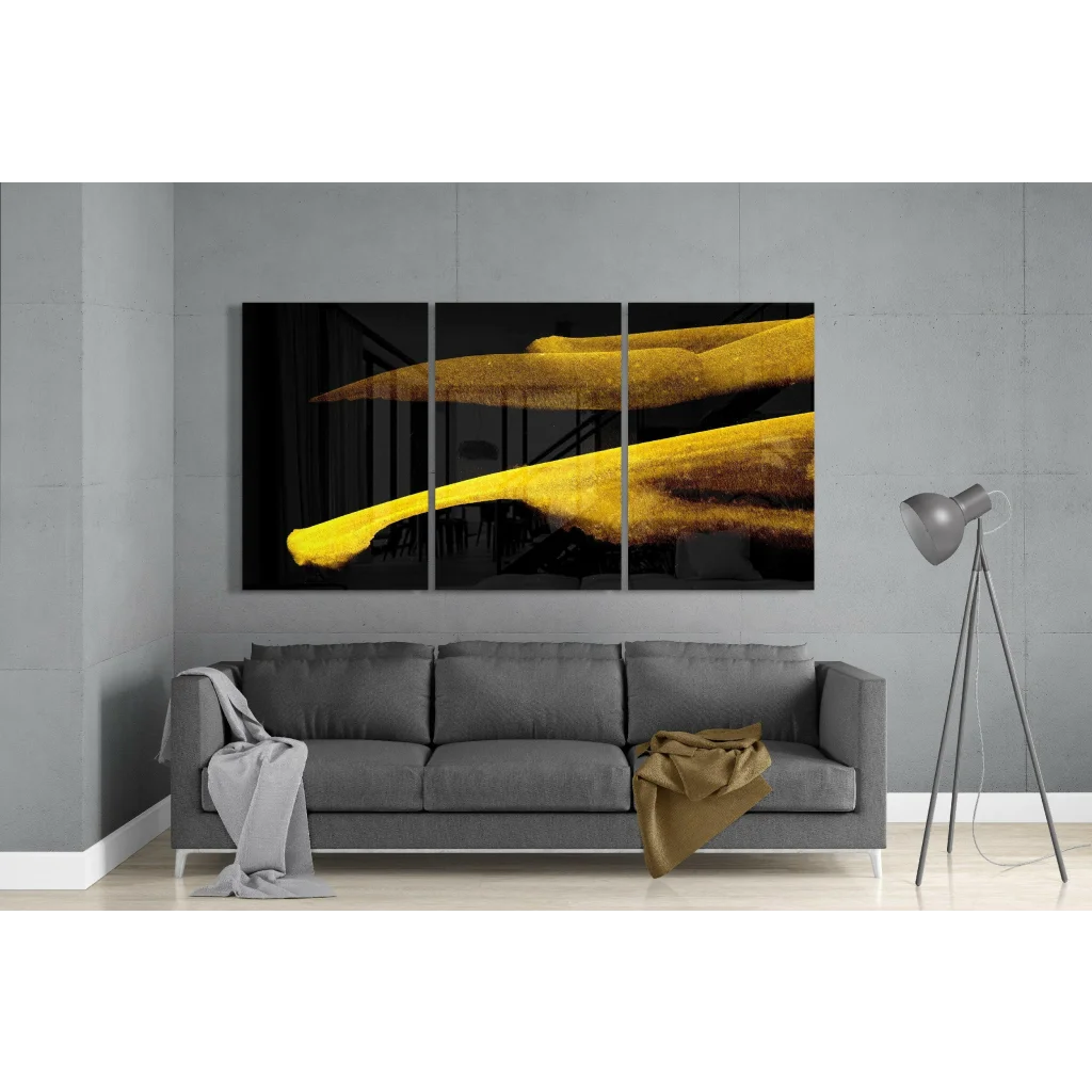 Golden brushstroke glass wall art triptych with yellow strokes on black