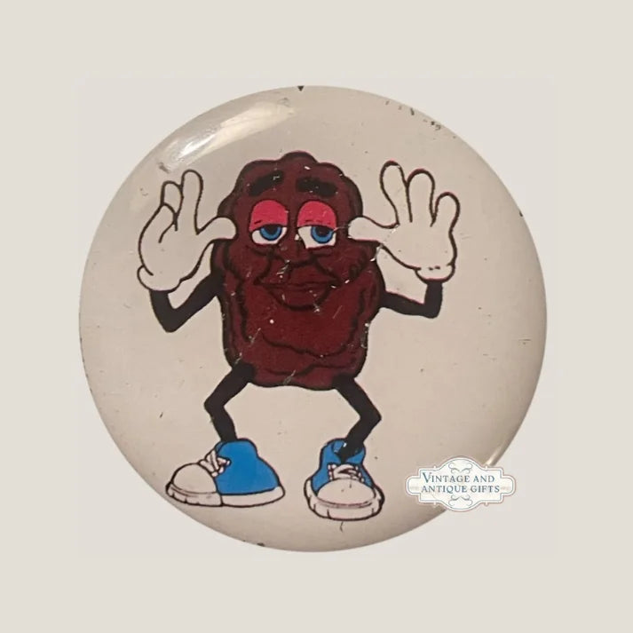 Vintage pin badge featuring cartoon California Raisin character with blue shoes and jazz hands.