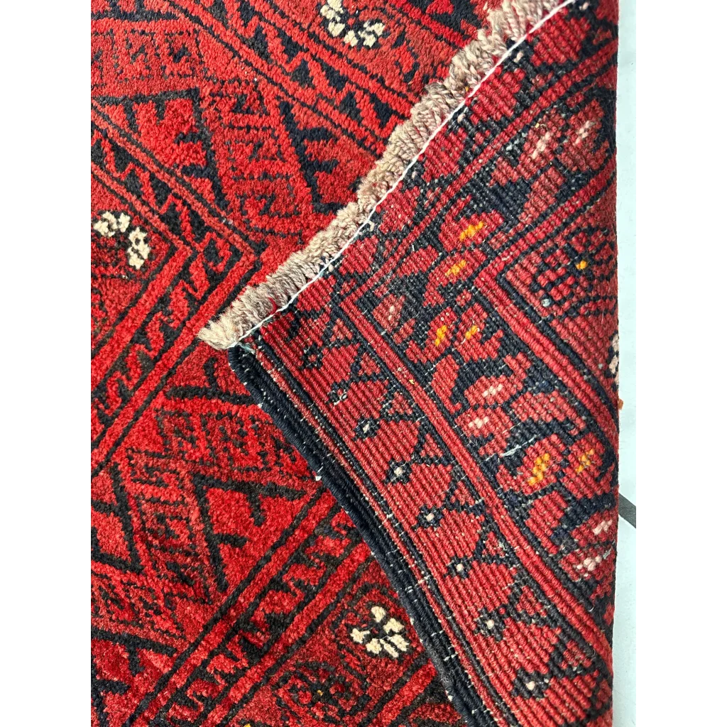 Vintage Afghan Turkoman Waziri wool rug with red geometric patterns