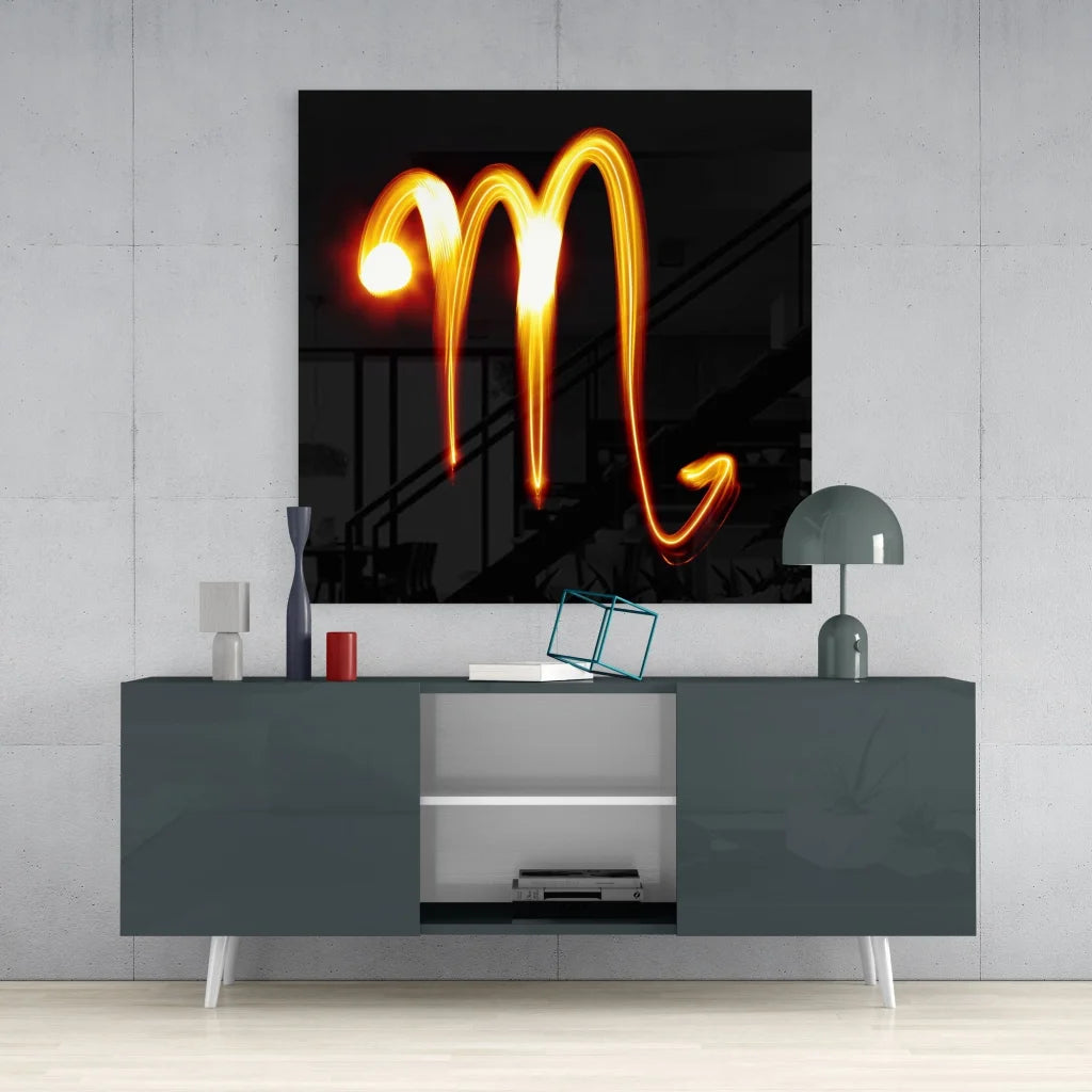 Glowing Scorpio zodiac tempered glass art with orange light trail on black background