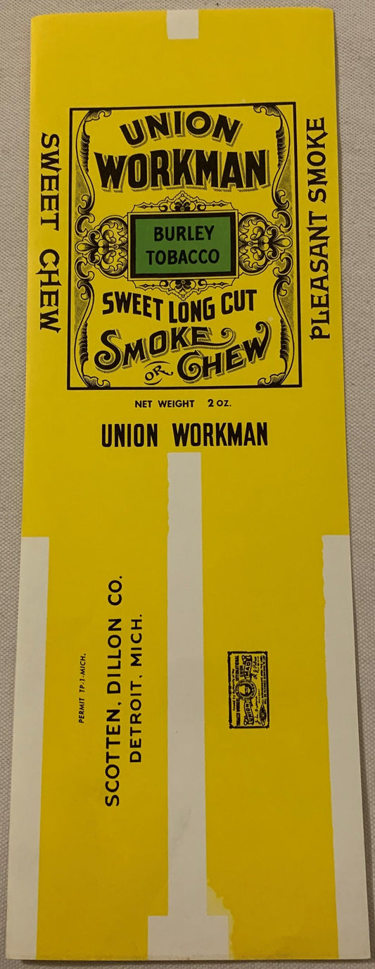 Vintage Union Workman Burley tobacco label, 2 oz, yellow with black ornate border and text, flat lay on textured surface