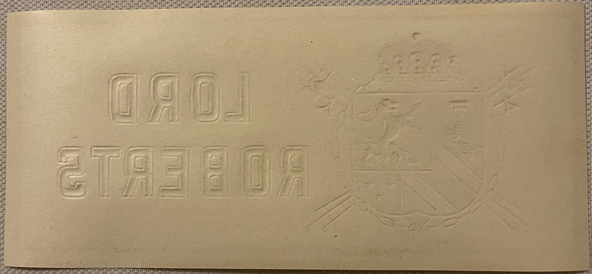 Cream-colored embossed cigar label featuring Cyrillic text reading "ДАД" and "2ТАСЕОА" with a heraldic eagle crest on the right side, photographed flat against fabric background.