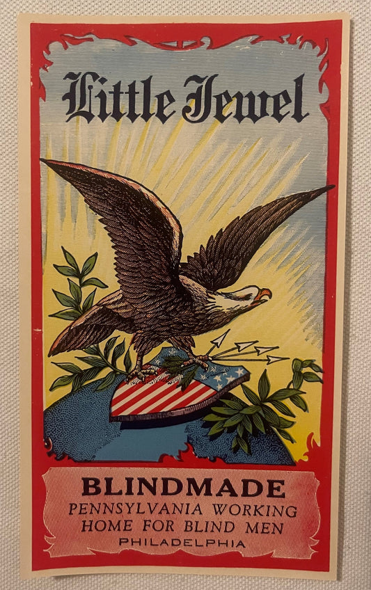 Vintage broom label with red border featuring an eagle grasping American shield, printed text "Little Jewel" and "Blindmade P