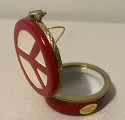 Vintage red and white porcelain peace sign hinged trinket box, shown open displaying silver interior, with brass hinge and tr