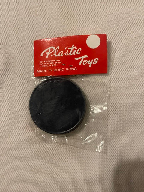 Vintage black plastic dexterity puzzle in clear packaging with red "Plastic Toys" label marked "Made in Hong Kong