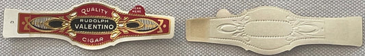 Two vintage cigar bands shown flat against gray fabric: ornate red and gold Rudolph Valentino band and plain embossed cream-c
