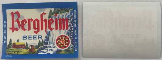 Vintage Bergheim Beer label front and back displayed flat, showing red gothic lettering, waterfall imagery, cabin scene, and