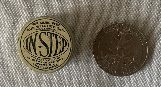 Vintage In-Step foot remedy tin next to quarter for scale, showing circular label with product name and Wayne NY address, fre