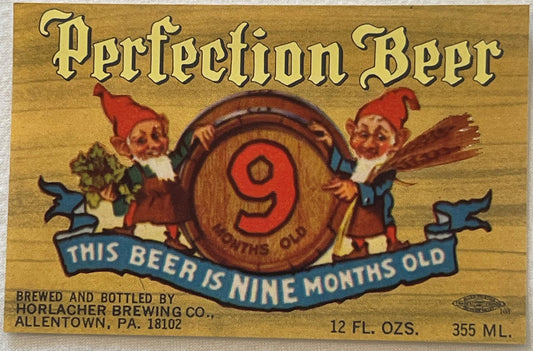 Vintage beer label with gold background, red gnomes holding a barrel marked "9", blue banner reading "THIS BEER IS NINE MONTH