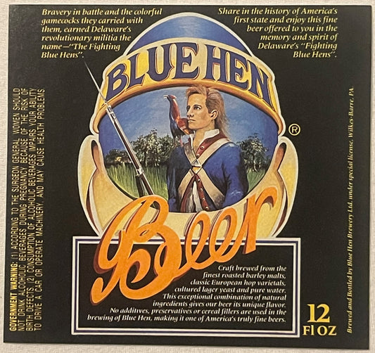Vintage Blue Hen beer label featuring a colonial soldier with rifle against blue background, gold and orange lettering, 12 fl