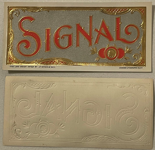 Two antique cigar labels: top shows red and gold embossed "Signal" text on gray ground; bottom shows cream-colored embossed d