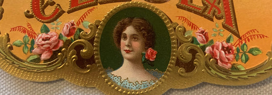 Antique cigar box label featuring portrait of woman in oval frame surrounded by embossed gold scrollwork and pink roses on or