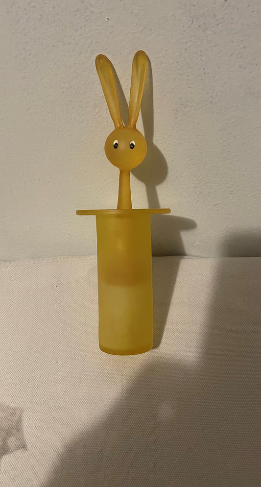 Yellow amber figural rabbit toothpick holder with long ears and blue eyes, emerging from cylindrical base, photographed again