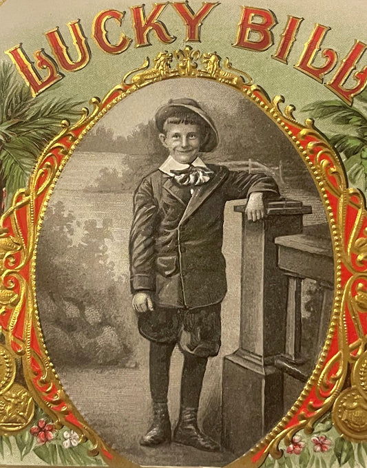 Antique Lucky Bill cigar box label with ornate gold and red frame, young boy in period clothing leaning against wooden furnit