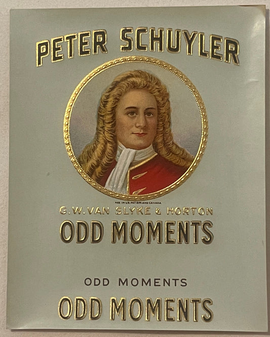 Embossed cigar box label with gold text reading "Peter Schuyler" and "Odd Moments," featuring portrait of man with long curle