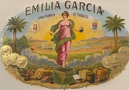 Vintage Emilia Garcia cigar box label featuring a woman in pink robes, palm trees, and ornate gold embossed borders with hera