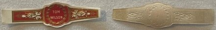 Front and back of vintage Tom Wilson cigar band showing ornate red and gold design with embossed cream-colored reverse side.