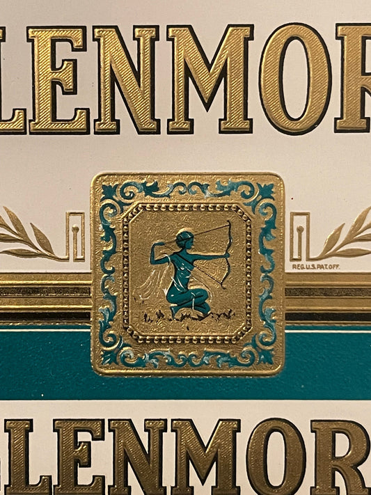 Antique Glenmore cigar label with gold embossed text, teal and gold decorative border, and central medallion featuring archer