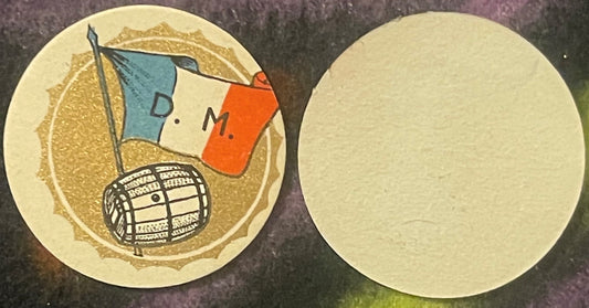 Two circular cream-colored wine barrel labels showing front and back sides; front features gold textured background, blue and