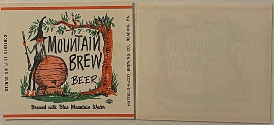 Vintage Mountain Brew Beer label showing wooden barrel, tree, and text "Brewed with Blue Mountain Water" from Hatfield-McCoy