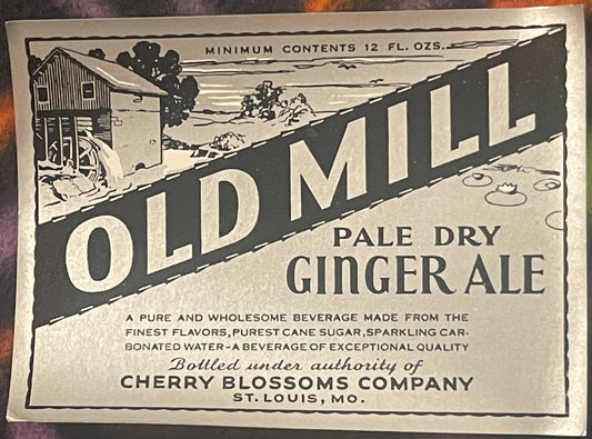 Vintage ginger ale label featuring "Old Mill" text, rural farm scene, and "Cherry Blossoms Company St. Louis MO" printed in b