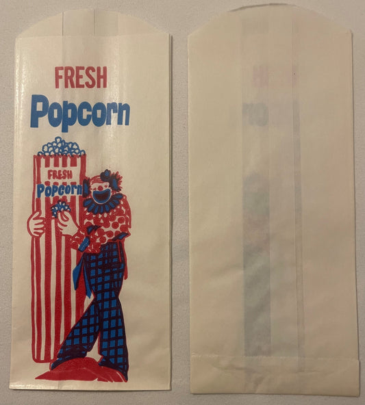 Vintage popcorn bag front and back showing red, white and blue clown illustration with striped popcorn container and "FRESH P