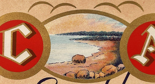Vintage beverage label featuring red circles with white geometric symbols flanking a central landscape scene with water and r