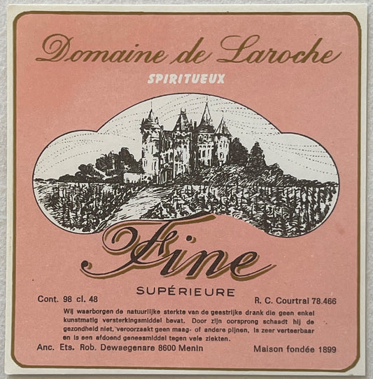 Vintage pink label for Domaine de Laroche spiritueux with engraved castle illustration surrounded by vineyard landscape