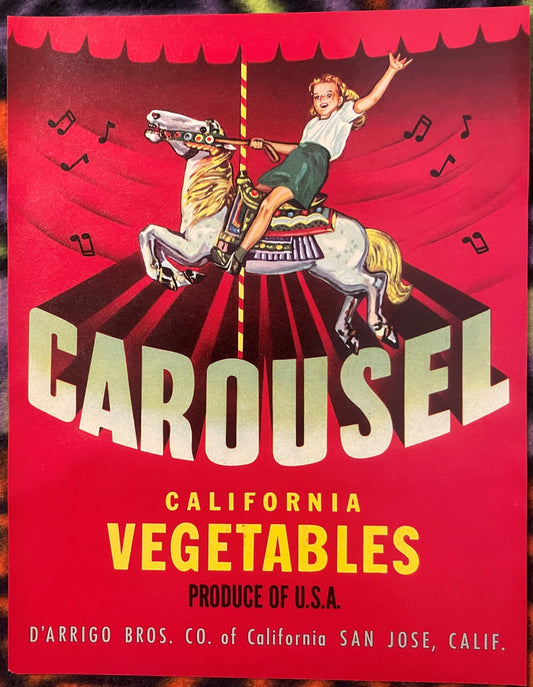 Vintage red produce crate label featuring a blond child riding a decorative carousel horse with musical notes, text reads "Ca