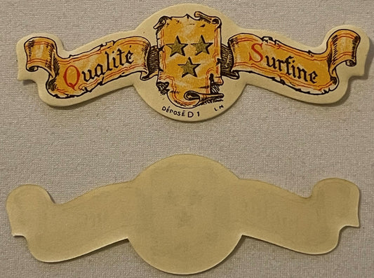 Vintage die-cut paper collar label with gold banners reading "Qualite" and "Surfine," three stars, and French text "DÉPOSÉ D