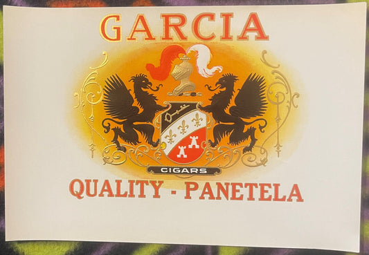 Antique Garcia cigar label with gold embossed heraldic crest, two black dragons, and red and white shield on cream background