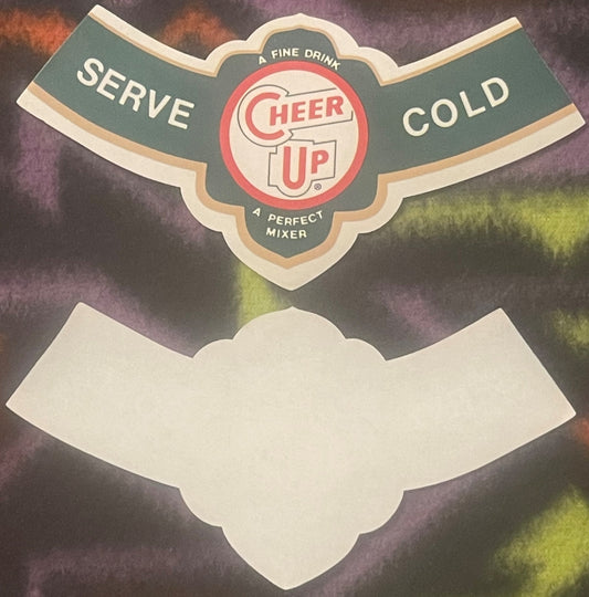 Vintage Cheer Up soda bottle neck label with red and green design, "Serve Cold" text visible, blank white banner at bottom ag