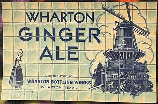 Vintage Wharton Ginger Ale label featuring blue text, Dutch woman illustration, and windmill graphic on cream tile background