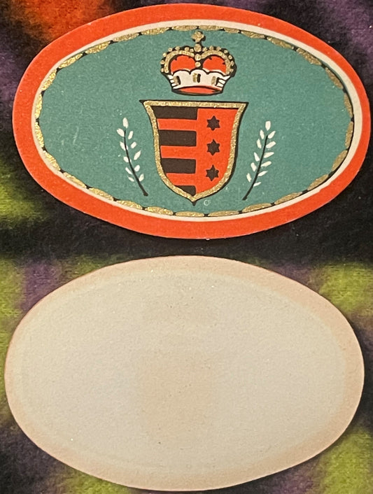 Antique wine neck label with red border, teal center, crown, heraldic shield with three red stars, laurel sprigs, and gold fo